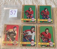 Five hockey cards displayed in plastic sleeves, featuring Montreal Canadiens players Lemaire, Tardif, Savard, Lapointe, and Bruins player Bucyk.