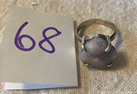 Raw amethyst ring photographed from the top with number 68 tag visible