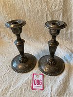 Two William A Rogers metal candle stick holders side by side showing full height and base details.