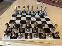 Front view of the complete chess board with chess pieces placed in starting position