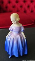 Front view of Royal Doulton figurine "Marie" showing gradient purple-blue dress and facial features.