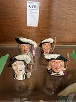 Group photo of all four Royal Doulton Three Musketeers character mugs showing front faces and details