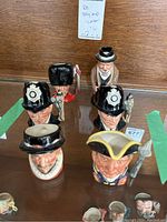 Photo showing five of the Toby mugs/jugs including two London Bobby mugs, Guardsman, Beefeater, and Williamsburg Guardsman, all with detailed painted faces and costumes