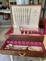 Wooden Rogers case opened, showing top drawer with eight knives and assorted utensils, lower drawer with loose spoons