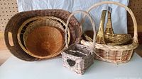 All five baskets displayed on a flat surface showing the assortment and sizes