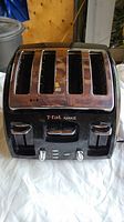 Front view of T-fal Avante four-slice toaster showing the slots and control buttons.