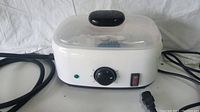 Front view of white MYWUBAO steam cleaner with black knob and switches and attached hose.
