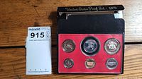 Six proof coins in clear protective cases mounted on red card with original black outer folder labeled United States Proof Set 1979 in background.