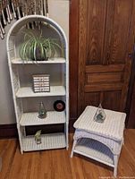 Full view of the off-white wicker two-tiered table showing the top and bottom shelf, giving scale and details of wicker weave pattern.