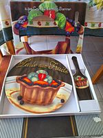 Boxed 2-piece serving set including plate and cake server featuring colorful fruit tart artwork with 'Tarte aux Fruits' text.