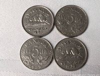Four Canadian 5 cents coins from 1935, 1936, 1937, and 1938 laid flat showing reverse sides with beaver design and Canadian maple leaves.