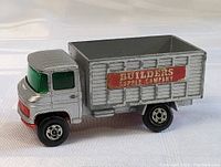 Front side view of the 1960s Matchbox Lesney scaffolding truck diecast toy showing 'Builders Supply Company' signage and green windshield.