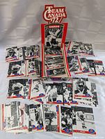 Wide view of the collection spread out with multiple stacks of hockey cards and one open display box featuring Team Canada '72 logo.