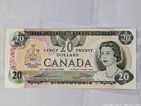Front side of 1979 Canadian twenty dollar bill showing Queen Elizabeth II portrait and Canadian coat of arms.