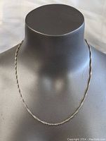 Full view of the sterling silver necklace displayed on a black mannequin bust, showing the necklace length and thickness.