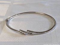 Full view of the sterling silver bracelet laid flat showing overall shape and clasp.
