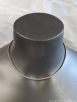 Front view of sterling silver thick chain necklace displayed on a mannequin bust, showing necklace fit and texture.