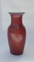 Front view of vase showing full form and deep red glaze
