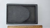 Top-down view of the rectangular black Chinese inkstone showing the ink grinding surface and reservoir area.