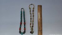 Photo showing both necklaces and a ruler for scale.