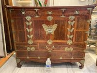 Front view with plastic bottle for scale showing full chest and hardware.