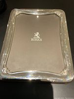 Front view of the large BIRKS sterling silver picture frame with the BIRKS logo visible on the display insert inside the frame.