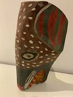 Front angled view of the vintage hand-carved wooden mask showing paint detail and form.