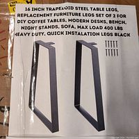 Photo showing illustration and text about the 16 inch trapezoidal steel table legs in satin black, designed for furniture like benches, coffee tables, desks, with max load 400 lbs and quick installation.