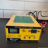 Front panel of Etrogo ET-168C intelligent battery charger showing digital display, mode switch, and LED indicators.