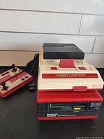 Famicom console with controllers and memory adapter attached