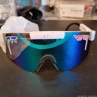 Front view of white speckled Pit Viper sunglasses with blue-purple mirrored lens and PIT VIPER logos.