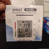 Front view of the retail box for the Wrist Blood Pressure Monitor W1681 showing screen layout and features.