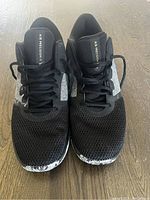 Front view of the black Nike Air Precision walking shoes showing mesh upper, laces and toe pattern details.