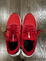 Top view of Nike Revolution men's shoes in red color size 9.5 showing the mesh upper, laces, and tongue label.