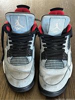 Top-front view of both Nike Air Jordan Gordon boots showing scuffs, dirt marks, black laces, mesh accents, and Jumpman logo on each tongue.