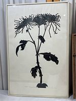Full view of framed black chrysanthemum floral silhouette print measuring approximately 13x20 inches.