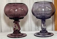 Two Viking glass goblets, one amethyst and one purple, shown side by side, highlighting their color and shape.