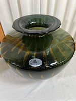 Front angled view of the green glass vase with visible gold infusion and Maestri Vetrai label