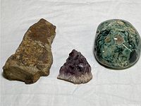 Photo of the three stones from above showing size and color differences