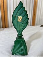 Full frontal view of green jade glass perfume bottle showing overall shape and stopper
