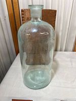 Full view of clear glass container in front of wooden box