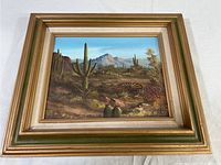Frontal view of the framed desert landscape painting showing the full artwork and frame.