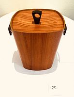 Top view of the teak ice bucket showing the wood grain and black wooden lid handle