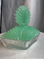 Green frosted glass lid with geometric step design and decorative finial on top