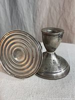 Photo of two vintage sterling silver candle stick holders showing overall shape, form, and surface condition.