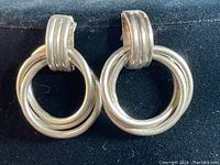 Close-up image of the vintage sterling silver Mexican 3 ring earrings showing front view.