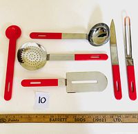 All six vintage Studio Nova cooking tools laid out on white surface with measuring ruler for scale