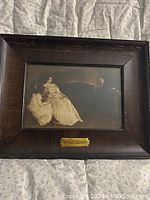 Frontal view of framed antique picture showing seated woman in dress and brass plaque labeled 'MENDELSSOHN'.
