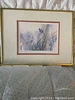 Framed signed print titled 'Coming of Spring' by Brent Heighton depicting grasses and butterflies in pastel tones, matted and framed in gold.