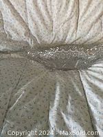 Clear heavy crystal dish with scalloped edges and boat shape placed on a fabric surface